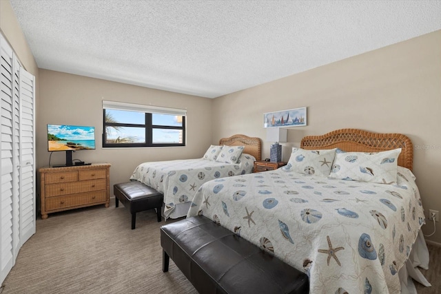 5780 Midnight Pass Rd Unit 410, Sarasota, FL 34242 - carpeted bedroom featuring a closet and a textured ceiling