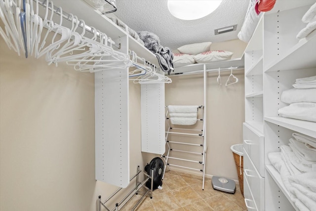 5780 Midnight Pass Rd Unit 410, Sarasota, FL 34242 - walk in closet featuring tile patterned floors