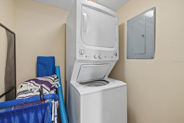 5780 Midnight Pass Rd Unit 410, Sarasota, FL 34242 - clothes washing area with a textured ceiling, stacked washer / drying machine, laundry area, and electric panel