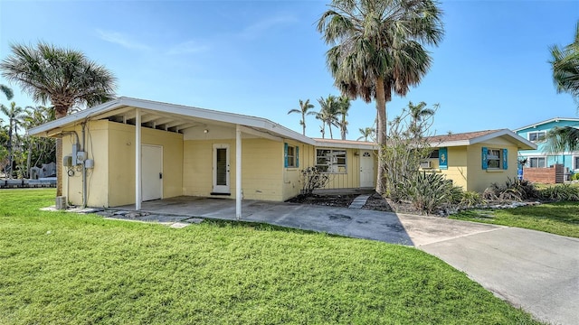 exterior space with a lawn and concrete block siding