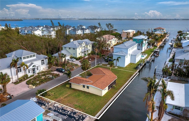 drone / aerial view featuring a water view and a residential view