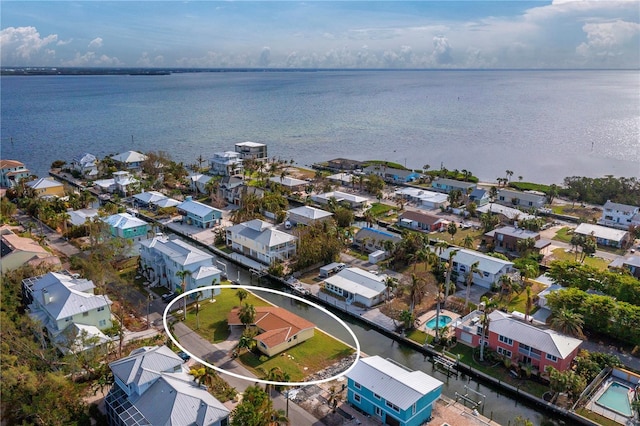drone / aerial view featuring a residential view and a water view
