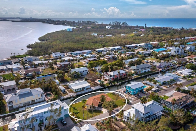 drone / aerial view with a water view and a residential view