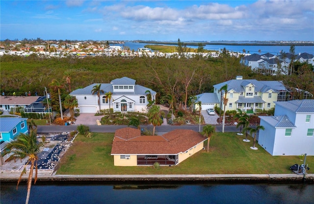 birds eye view of property with a water view and a residential view