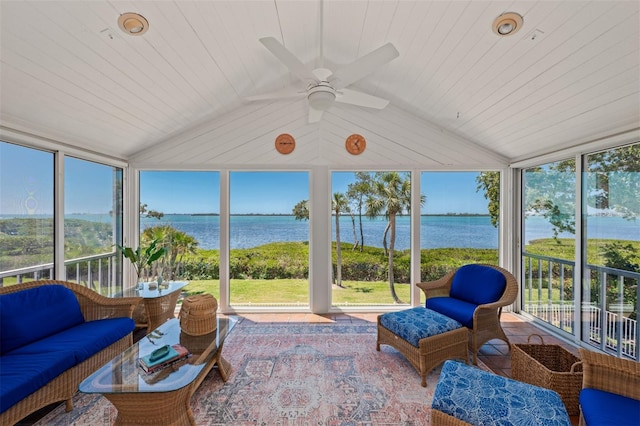sunroom featuring a water view, a ceiling fan, and expansive windows