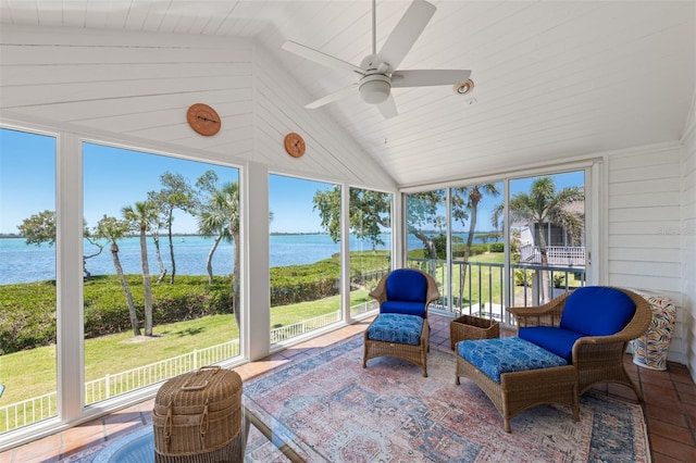 sunroom featuring a ceiling fan and a water view