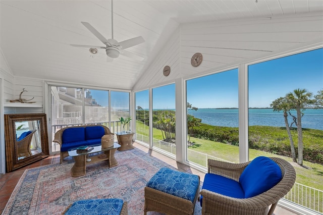 sunroom / solarium featuring floor to ceiling windows, a water view, and lofted ceiling