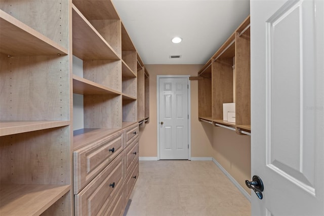 spacious closet featuring light floors and visible vents