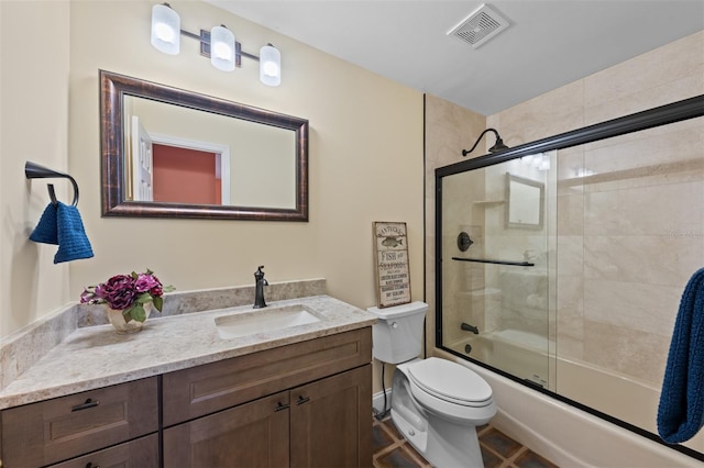 bathroom with visible vents, tile patterned flooring, vanity, bath / shower combo with glass door, and toilet