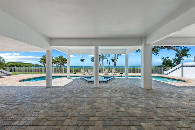 community pool with a hot tub, a patio, and a fenced backyard