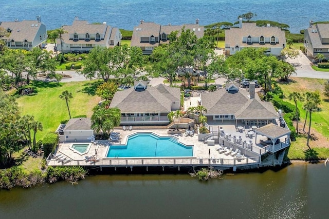 birds eye view of property with a water view and a residential view