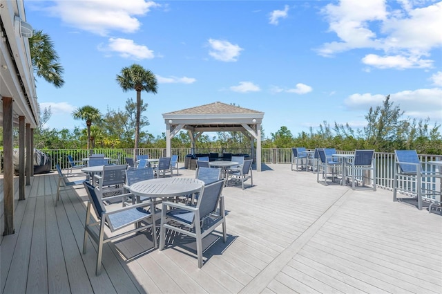 deck featuring a gazebo and outdoor dining area