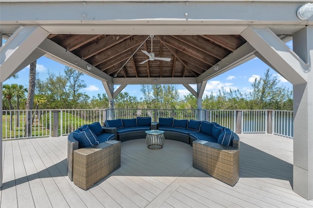 wooden terrace featuring an outdoor hangout area, a gazebo, and ceiling fan