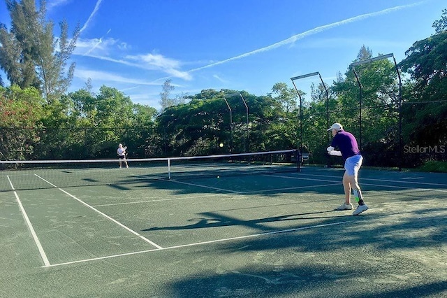 view of tennis court with fence