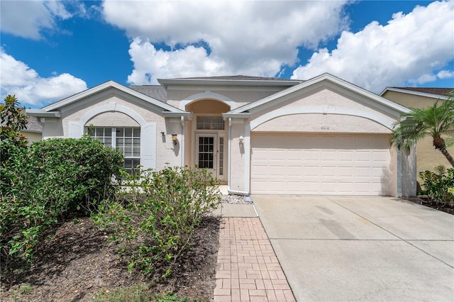 4610 Runabout Way, Bradenton, FL 34203 - ranch-style house featuring stucco siding, a garage, and concrete driveway