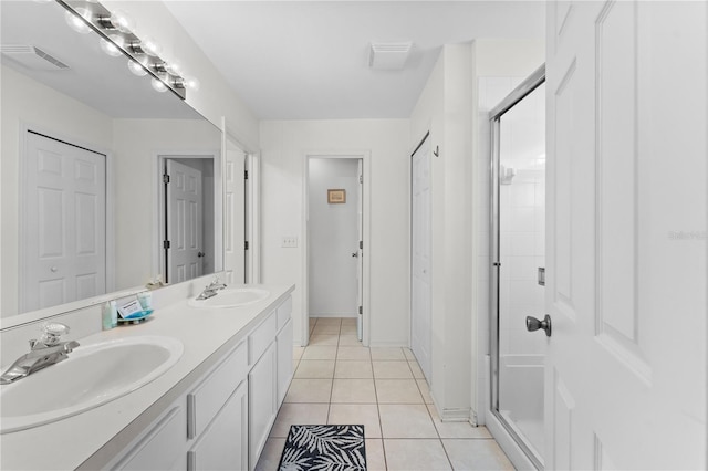 4610 Runabout Way, Bradenton, FL 34203 - bathroom with a shower stall, tile patterned flooring, double vanity, and baseboards