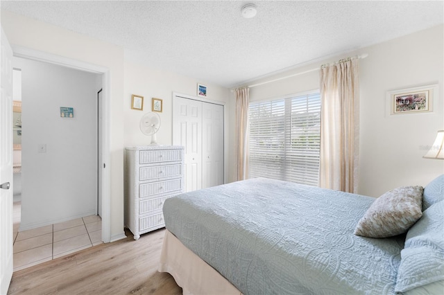 4610 Runabout Way, Bradenton, FL 34203 - bedroom with wood finished floors, a textured ceiling, and a closet