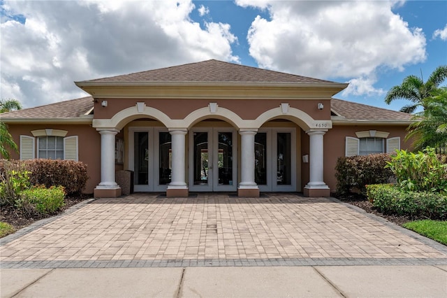 4610 Runabout Way, Bradenton, FL 34203 - view of front of house featuring french doors, stucco siding, and a shingled roof