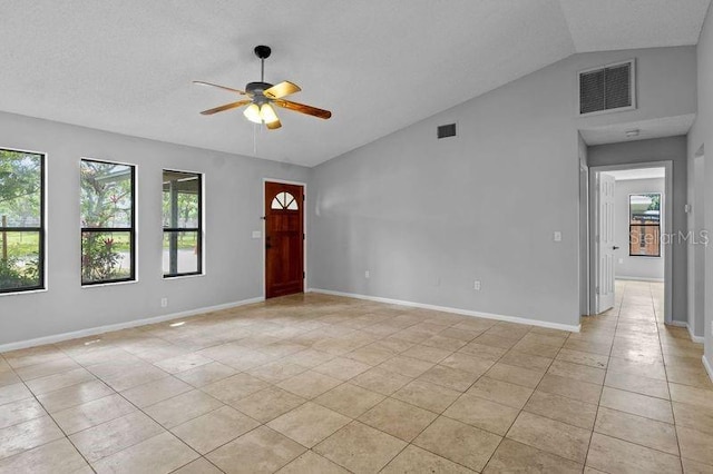 920 36th St W, Bradenton, FL 34205 - empty room featuring a ceiling fan, light tile patterned floors, plenty of natural light, lofted ceiling, and baseboards