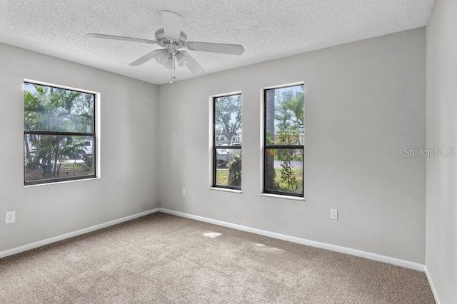 920 36th St W, Bradenton, FL 34205 - carpeted spare room featuring baseboards, a ceiling fan, and a textured ceiling