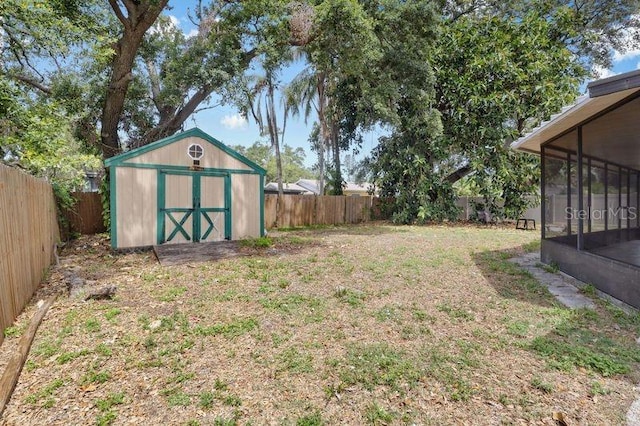 920 36th St W, Bradenton, FL 34205 - view of yard featuring a storage shed, a sunroom, and an outbuilding