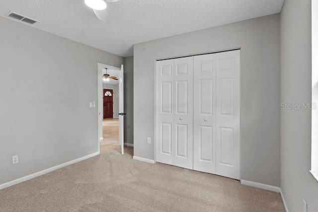 920 36th St W, Bradenton, FL 34205 - unfurnished bedroom with carpet flooring, a closet, a textured ceiling, and baseboards