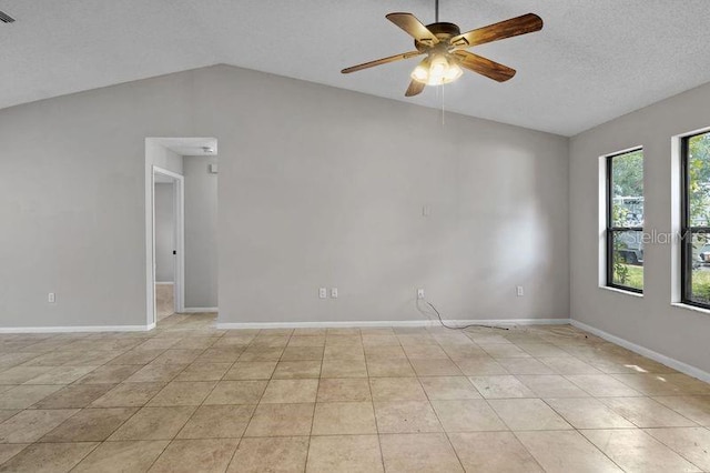 920 36th St W, Bradenton, FL 34205 - spare room with a ceiling fan, lofted ceiling, baseboards, light tile patterned floors, and a textured ceiling