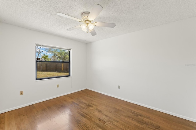 6547 Samoa Dr, Sarasota, FL 34241 - spare room with a textured ceiling, wood finished floors, baseboards, and ceiling fan