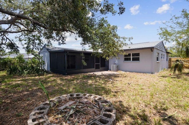 3505 27th Ave W, Bradenton, FL 34205 - rear view of house with a fire pit, a sunroom, cooling unit, and a yard