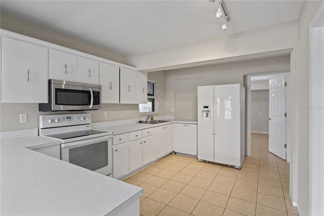 3505 27th Ave W, Bradenton, FL 34205 - kitchen with white appliances, light countertops, light tile patterned floors, white cabinets, and a sink