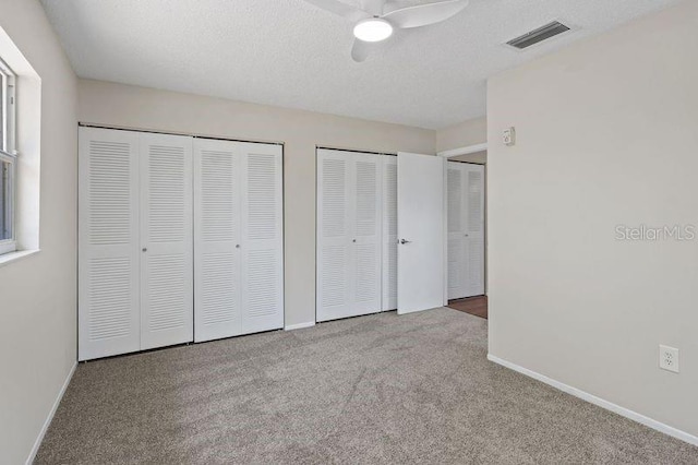 3505 27th Ave W, Bradenton, FL 34205 - unfurnished bedroom featuring multiple closets, carpet flooring, and baseboards