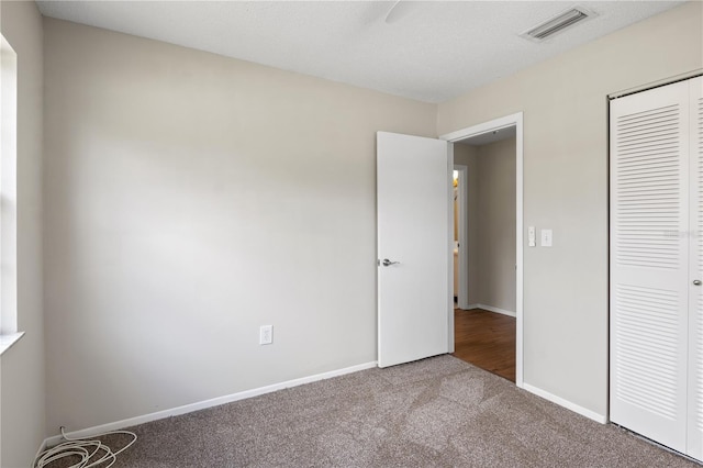 3505 27th Ave W, Bradenton, FL 34205 - unfurnished bedroom featuring carpet flooring, a closet, and baseboards