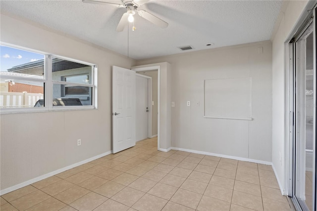 3505 27th Ave W, Bradenton, FL 34205 - spare room with a textured ceiling, ceiling fan, baseboards, and light tile patterned flooring