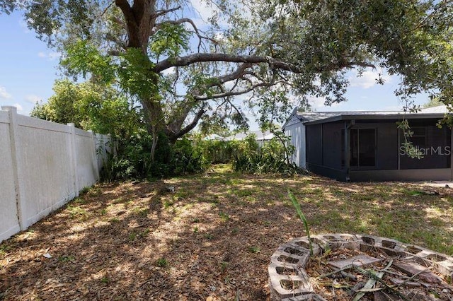 3505 27th Ave W, Bradenton, FL 34205 - fenced backyard with an outdoor fire pit and a sunroom