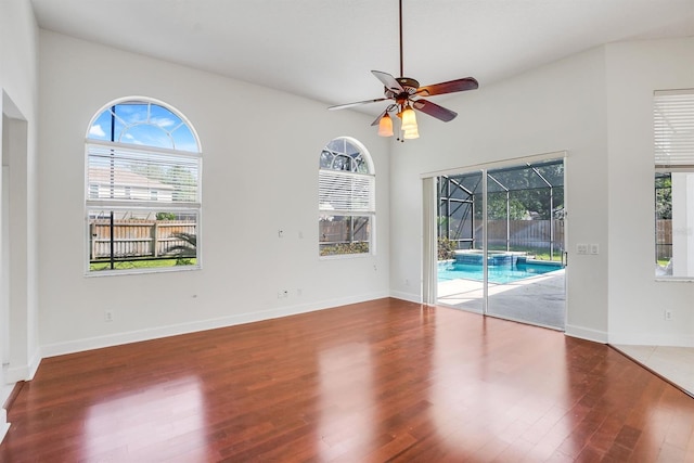 1125 English Garden Ln, Winter Garden, FL 34787 - empty room featuring wood finished floors, a sunroom, ceiling fan, and a healthy amount of sunlight