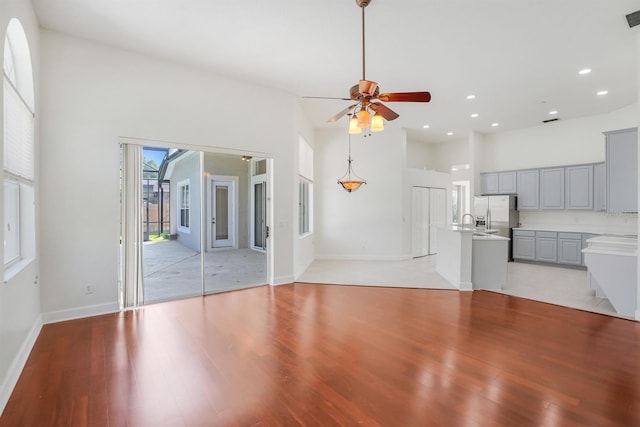 1125 English Garden Ln, Winter Garden, FL 34787 - unfurnished living room with recessed lighting, a towering ceiling, light wood finished floors, and ceiling fan