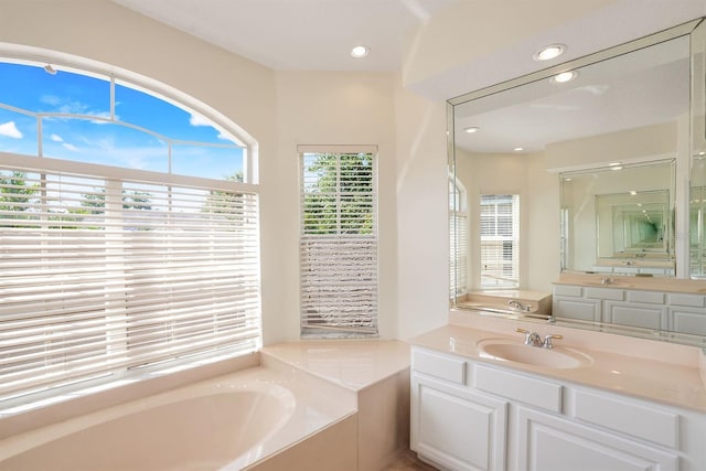1125 English Garden Ln, Winter Garden, FL 34787 - bathroom featuring a garden tub, vanity, and recessed lighting