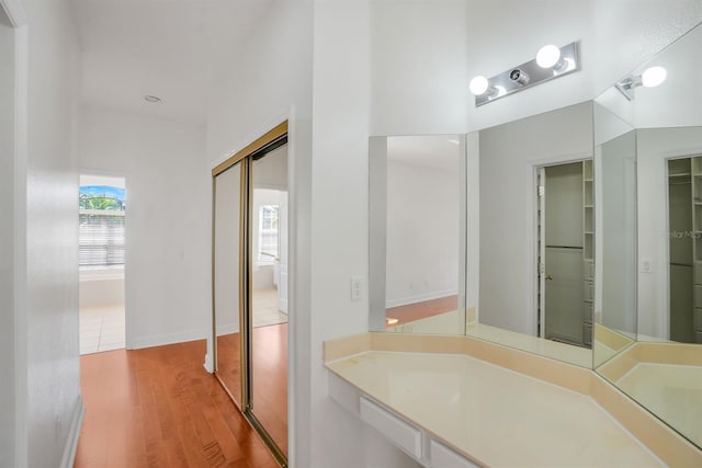1125 English Garden Ln, Winter Garden, FL 34787 - bathroom featuring wood finished floors, vanity, and a walk in closet