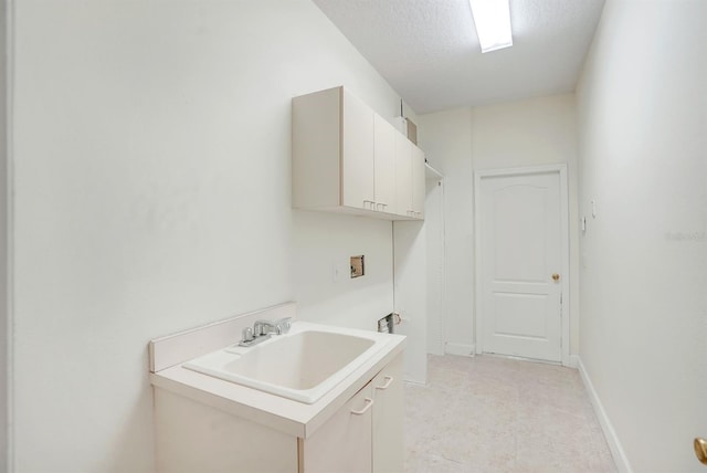 1125 English Garden Ln, Winter Garden, FL 34787 - laundry area with cabinet space, washer hookup, a textured ceiling, and a sink