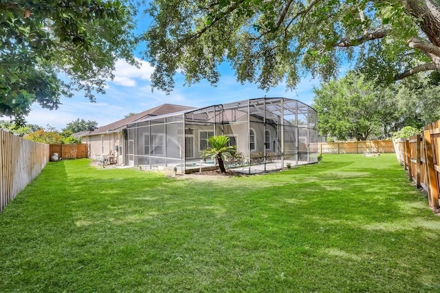 1125 English Garden Ln, Winter Garden, FL 34787 - back of property with a fenced backyard, a yard, and glass enclosure
