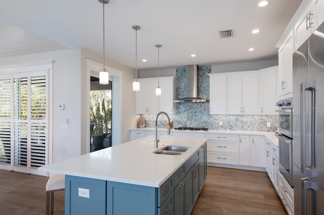 222 Willow Ave, Anna Maria, FL 34216 - kitchen featuring light countertops, backsplash, dark wood finished floors, and wall chimney exhaust hood