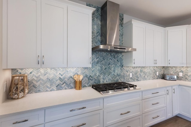 222 Willow Ave, Anna Maria, FL 34216 - kitchen with light countertops, stainless steel gas cooktop, wall chimney exhaust hood, and white cabinetry