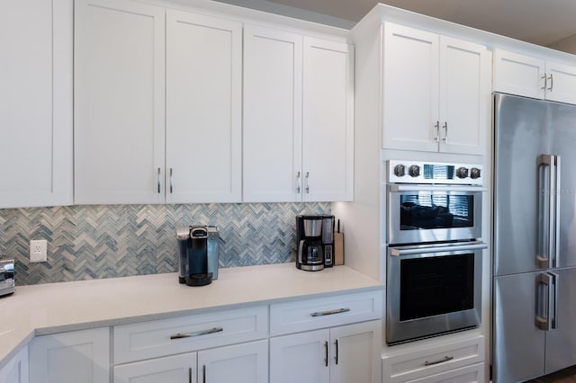 222 Willow Ave, Anna Maria, FL 34216 - kitchen featuring light countertops, white cabinetry, backsplash, and stainless steel appliances