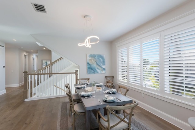 222 Willow Ave, Anna Maria, FL 34216 - dining space with a chandelier, baseboards, visible vents, and wood finished floors
