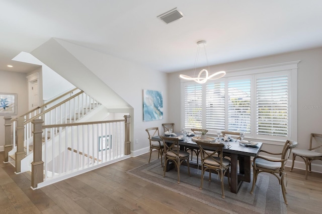 222 Willow Ave, Anna Maria, FL 34216 - dining area with a notable chandelier, wood-type flooring, recessed lighting, baseboards, and visible vents