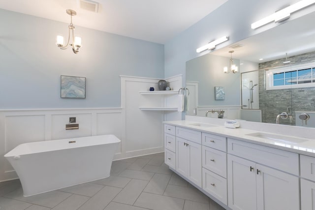 222 Willow Ave, Anna Maria, FL 34216 - full bathroom featuring double vanity, visible vents, a shower stall, a sink, and a notable chandelier