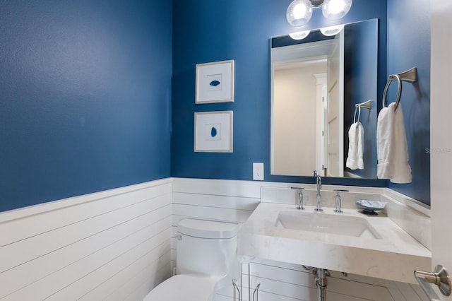 222 Willow Ave, Anna Maria, FL 34216 - bathroom featuring a sink, wainscoting, and toilet