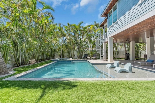 222 Willow Ave, Anna Maria, FL 34216 - view of pool featuring a lawn, a pool with connected hot tub, a patio area, a fenced backyard, and stairs