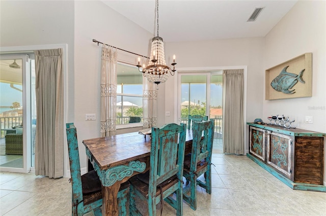 dining room featuring light tile patterned floors, visible vents, and an inviting chandelier