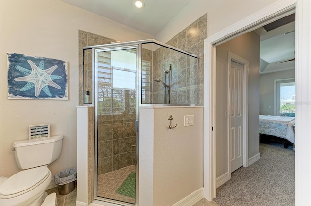 bathroom featuring baseboards, ensuite bathroom, a shower stall, and toilet